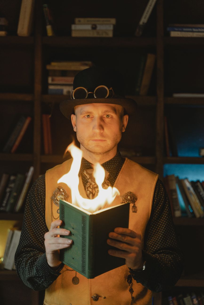 a man holding a book with fire