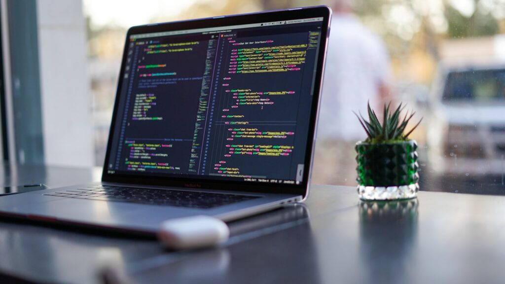 Laptop met programmacode als beeld voor samenwerking tussen ontwikkelaars en AI-agenten