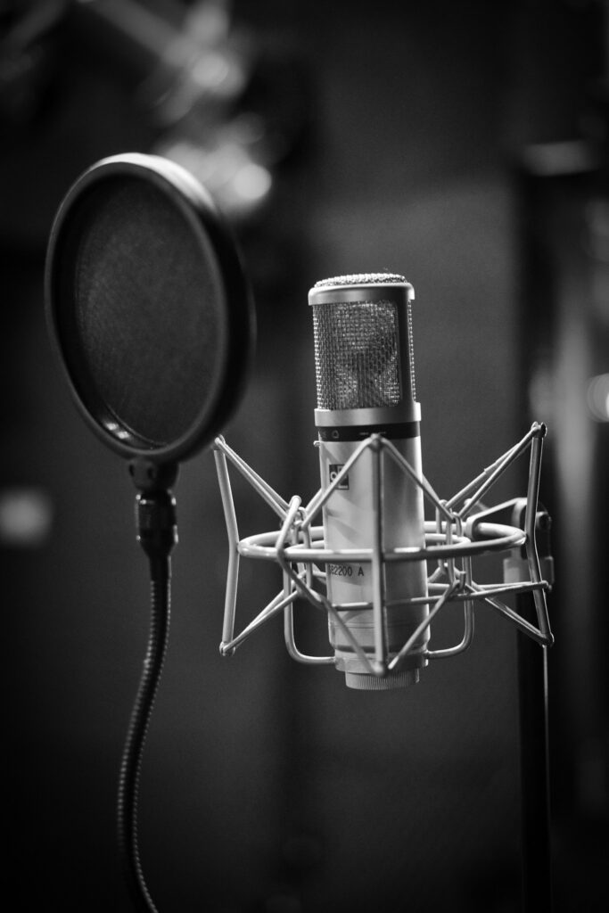 Zwart-witfoto van een condensatormicrofoon in een opnamestudio